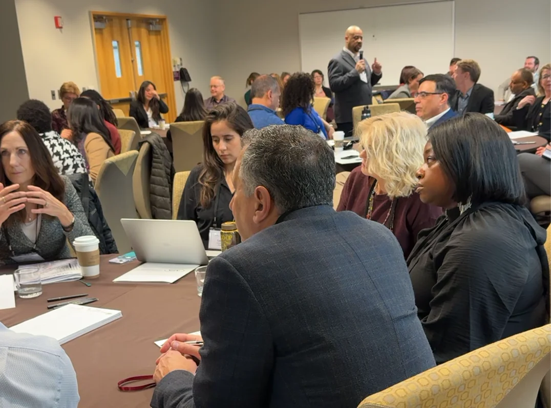 Mike Roberts leading a workshop among participants seated at tables